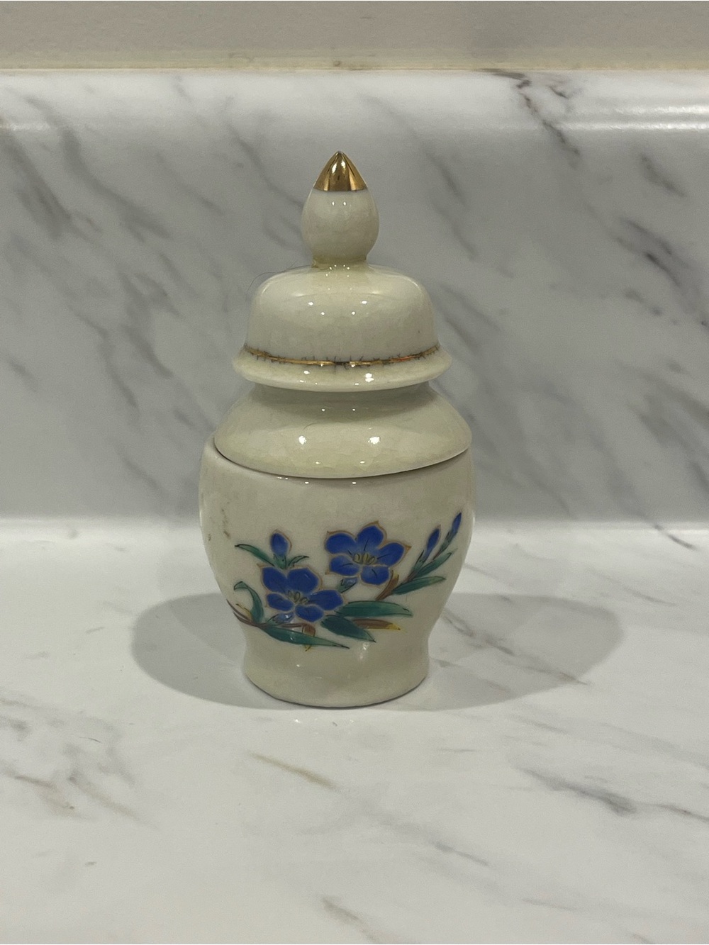 Vintage Enesco Porcelain Jar with candle inside.
